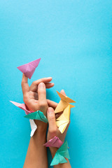 Mental health concept. Colorful paper butterflies flying and sitting on womans hands. Harmony emotion. Origami. Paper cut style. - obrazy, fototapety, plakaty