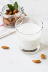 Almond milk in a glass on a white background. Organic vegan milk