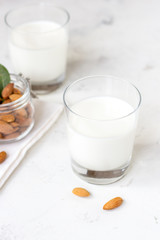 Almond milk in a glass on a white background. Organic vegan milk