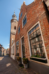 Dutch narrow street with old facades and church tower