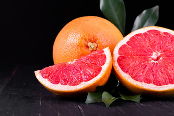 orange and grapefruit juice On a wooden black background
