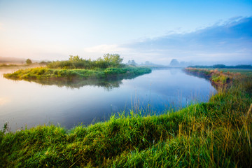 River curve under blue sky landscape. Sunny morning in the rural area