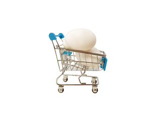 Group of chicken eggs in red shopping cart on wooden table. How to buy good quality look at the shell of it. If fresh, there is a sticky powder. Business concept.