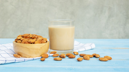 Almond milk on a blue wooden table.