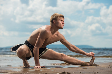 Fototapeta na wymiar athlete warm up before training against the sea