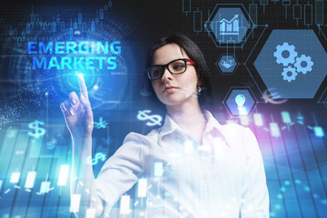 The concept of business, technology, the Internet and the network. A young entrepreneur working on a virtual screen of the future and sees the inscription: Emerging markets