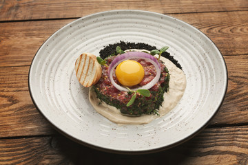 Raw veal tartare with sauce, quail egg and crouton