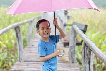 a boy funny playing with umbrella