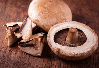 portobello mushrooms over old wood background