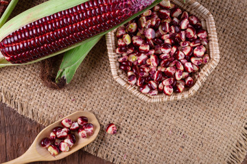 Fresh corn on cobs on rustic wooden table, closeup