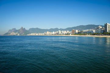 Scenic panoramic view of Ipanema Beach from the rocks at Arpoador with the city skyline in Rio de Janeiro Brazil