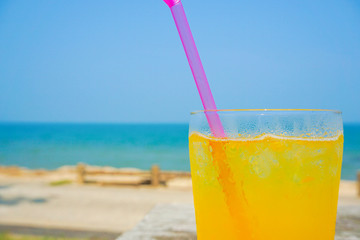 Orange juice drinking on the beach.  ビーチで飲むオレンジジュース