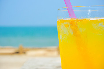 Orange juice drinking on the beach.  ビーチで飲むオレンジジュース
