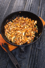 Fried chanterelle mushrooms in a cast iron pan