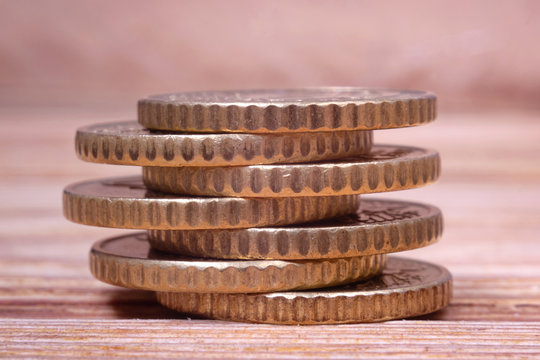 Several Euro Coins are stacked in a pile