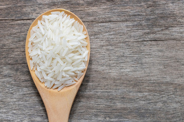 uncook rice in wood spoon