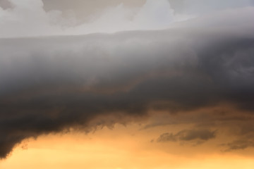 Dramatic fiery stormy sky in a mixture of yellow, orange, gray and black colors