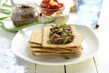 Mushroom pate and dried tomatoes with crackers, mousse