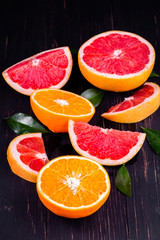 Fototapeta na wymiar orange and grapefruit juice On a wooden black background