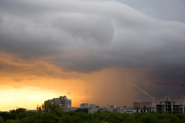 Dramatic fiery stormy sky in a mixture of yellow, orange, gray and black colors