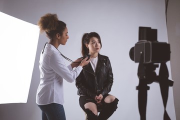 Female photographer recording an interview using voice recorder