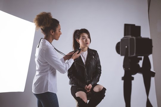Female photographer recording an interview using voice recorder