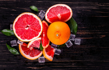 orange and grapefruit juice On a wooden black background

