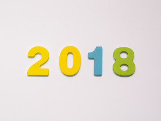 Colorful wooden numbers of 2018 on white background. New year concept.