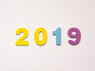 Colorful wooden numbers of 2019 on white background. New year concept.