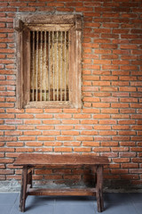 Fototapeta na wymiar old wood bench and brick wall