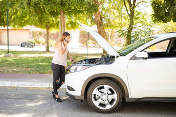 Woman calling roadside assistance for help