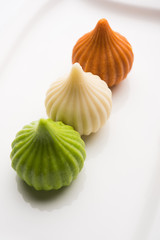 Sweet Tiranga coloured modak shape mithai or dumpling for Independence or republic day greeting card