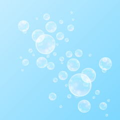 Realistic soap bubbles with rainbow reflection set isolated on the blue background.