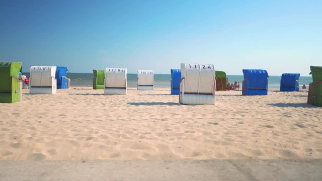 German beach on the North Sea island F&ouml;hr. This place is called Wyk and is a small town on the island. Parallax shot of the beach chairs, that you find on northern German beaches.