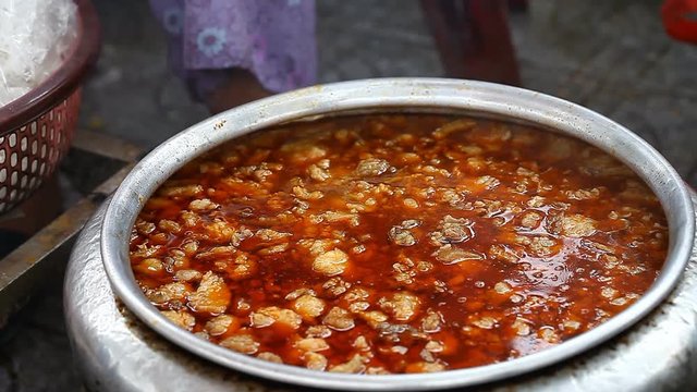 Asian street food. A large vat of soup close-up