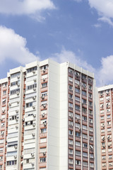 Vertical shot of tall concrete mass housing building corner in Izmir at Turkey with blue sky background