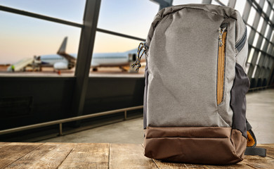Backpack on desk and airport background