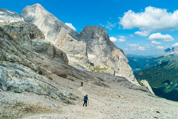 Naklejka premium Via ferrata Tofana di Mezzo climbers on the ridge in the Dolomites, Group of climbers on the mountain top, Dolomite Alps, Italy. Silhouette of people climbing the mountain. Tiny Man Big Landscape 