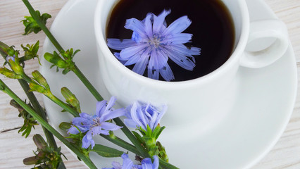 Delicious and healthy beverage from chicory, on wooden background.