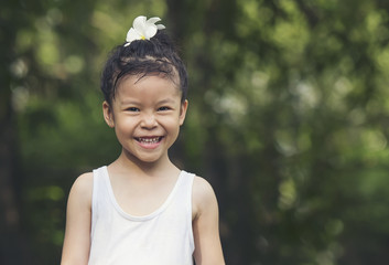 Happy little girl having fun at the park