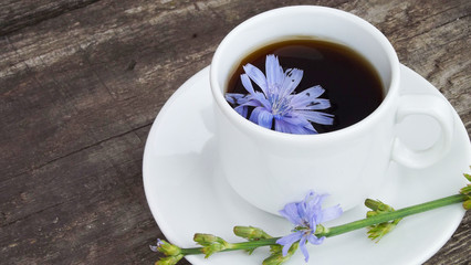 Delicious and healthy beverage from chicory, on wooden background.