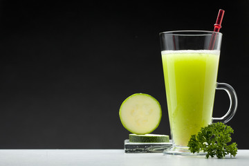 green smoothie on black background with blank space for text