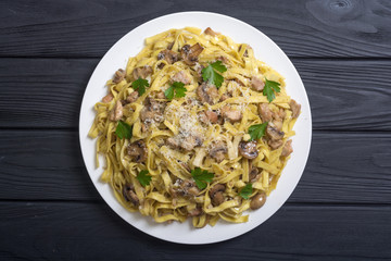 Pasta tagliatelle with chicken meat and mushroom