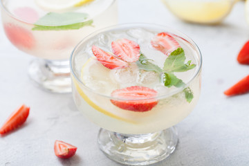 Citrus linfused emonade water with lemon sliced , healthy and detox water drink in summer on concrete table.