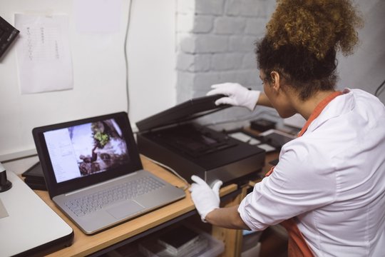 Female photographer using photo scanner