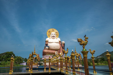 Chinese Laughing Buddha at Plai Laem Temple - Main Symbol and Popular Landmark of Samui Island in Thailand. Tourism and Sightseeing
