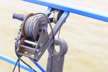 A small motor ship carries a mechanical winch on board © sir270