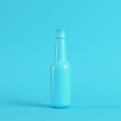 Blank bottle with stopper on bright blue background in pastel colors