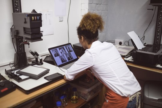 Female photographer developing photos