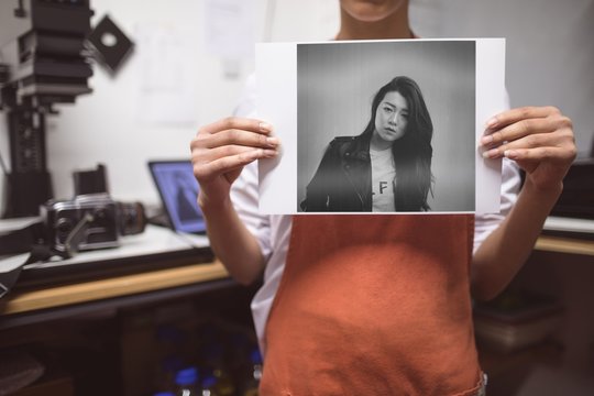 Female photographer showing photos in photo studio